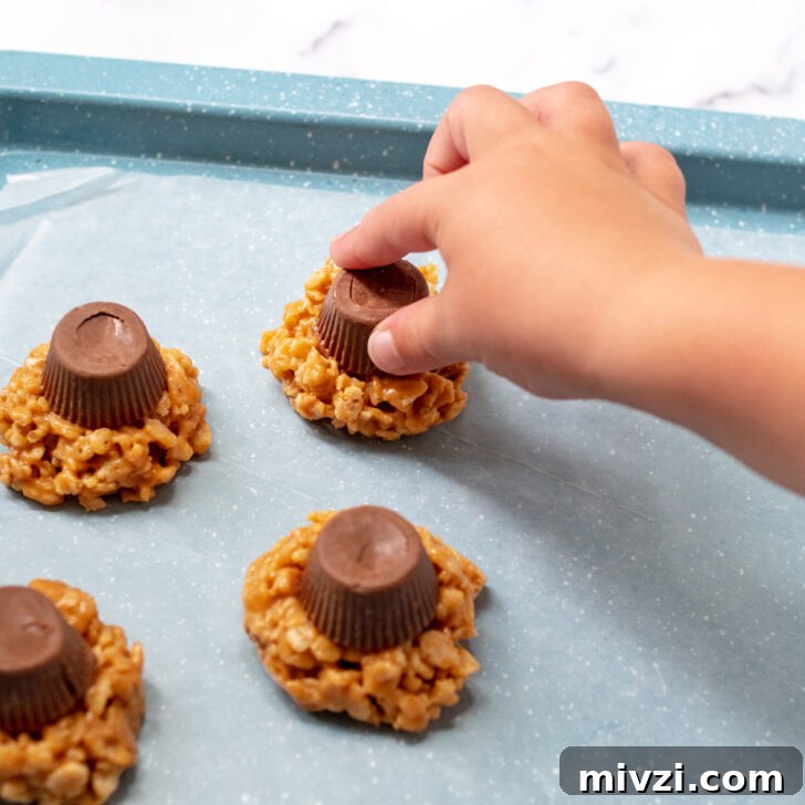 a child's hand placing on the peanut butter cup.