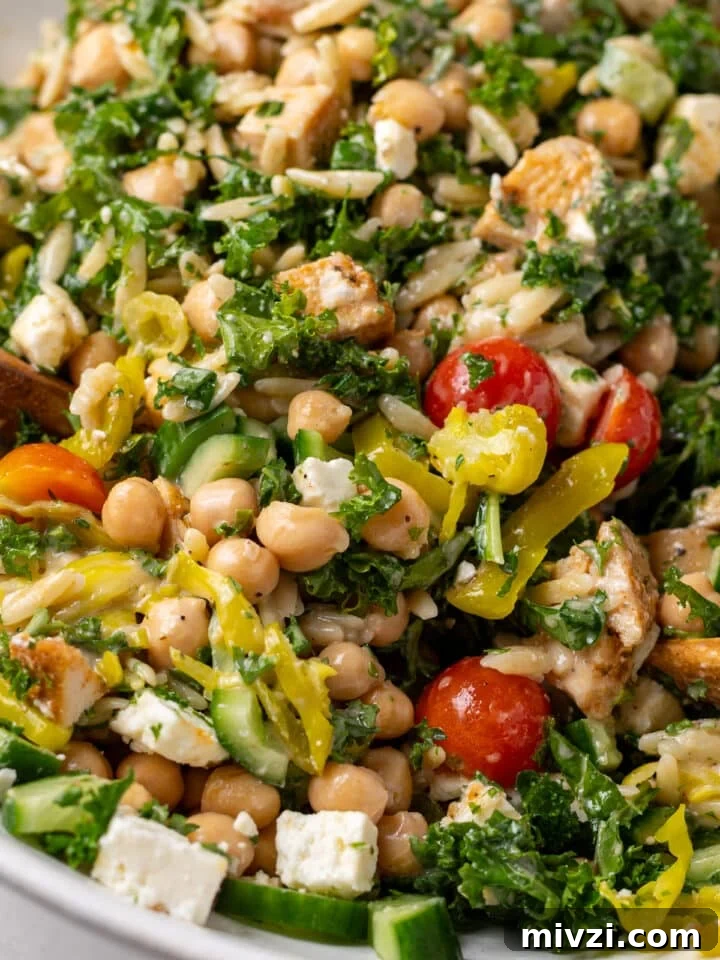 close up view of a chicken and chickpea salad with feta and tomatoes