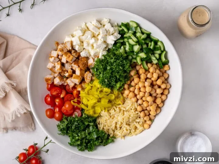 chicken and chickpea salad assembled in a large white serving bowl