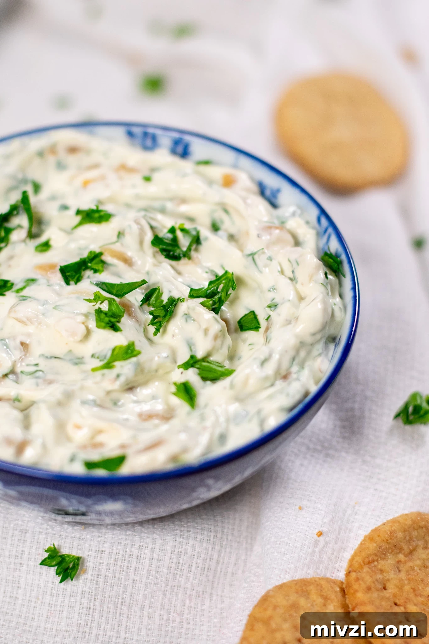 Dip with onion and dill in a bowl.