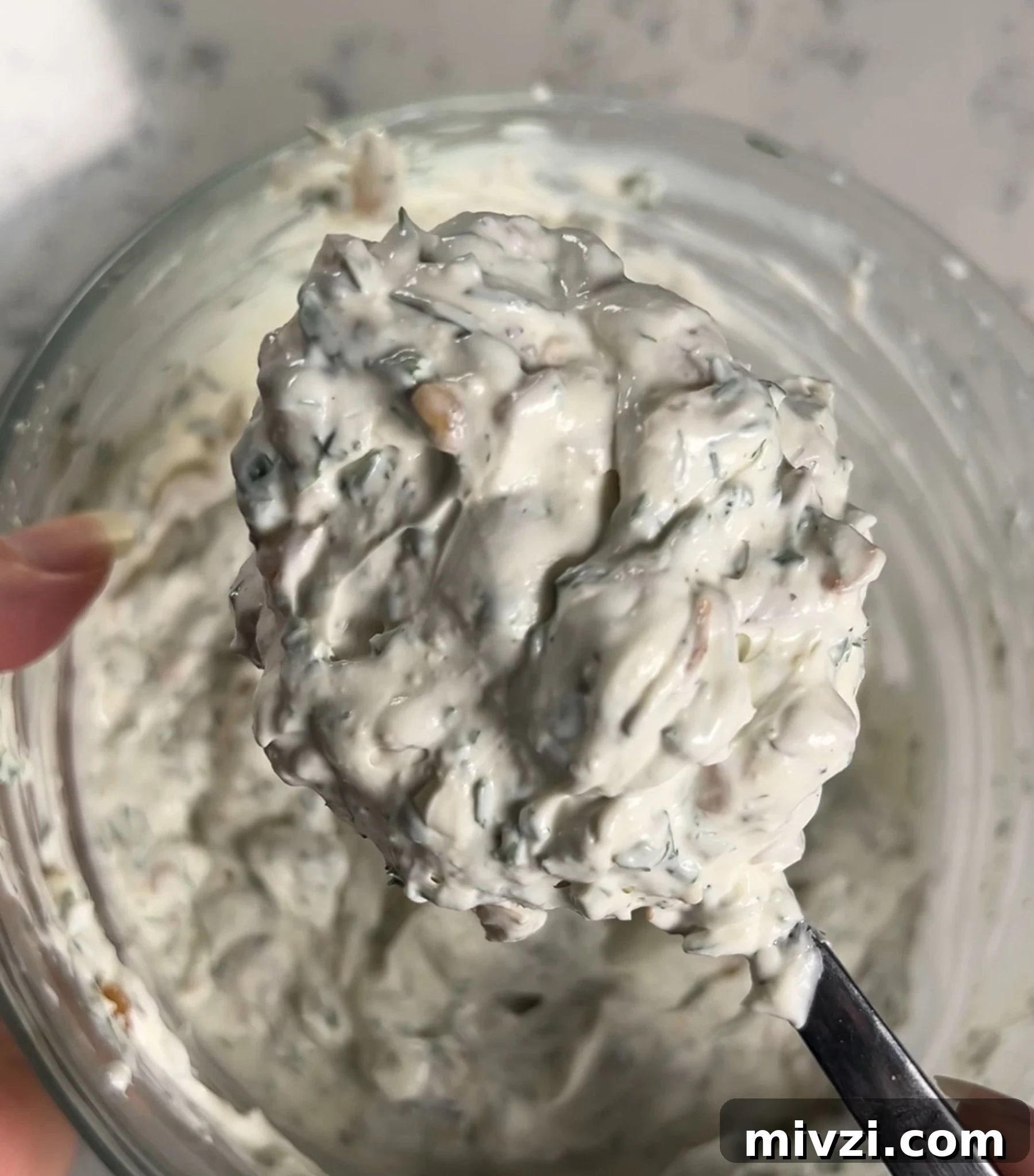 Mixing together the dip.