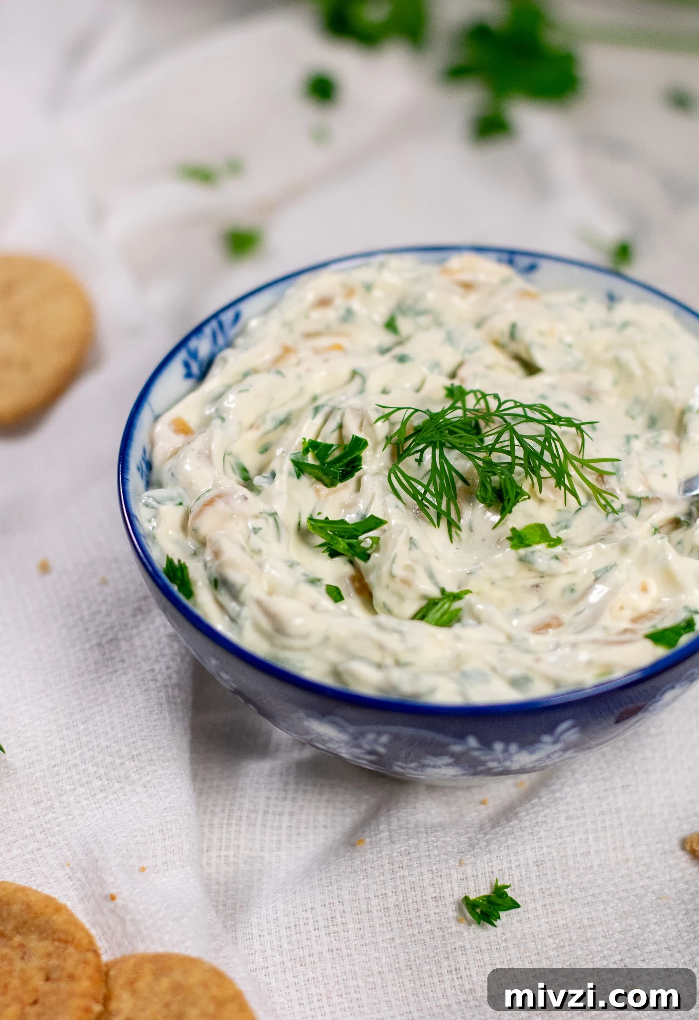 Dip with onion and dill in a bowl.