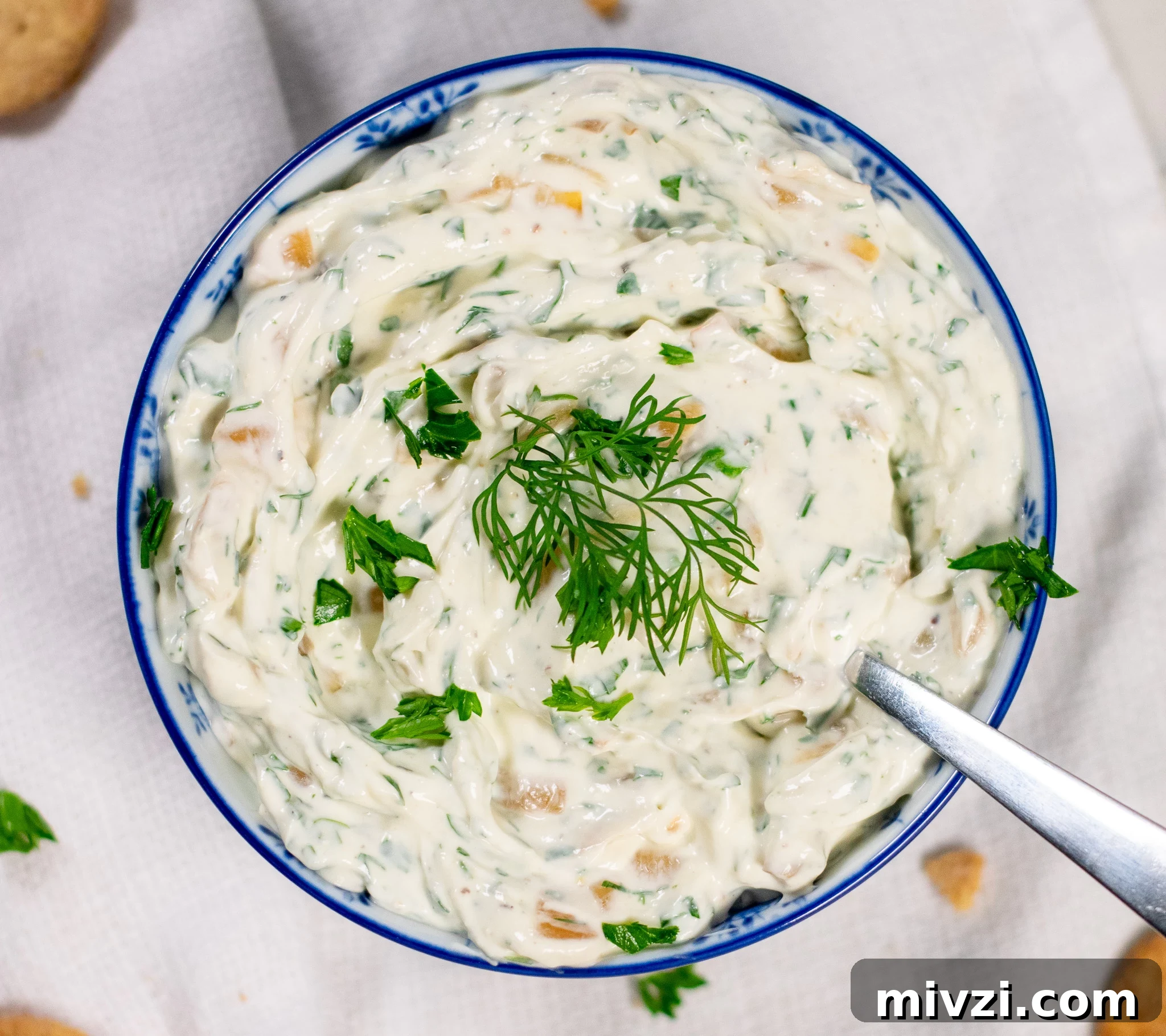 Dip with onion and dill in a bowl.