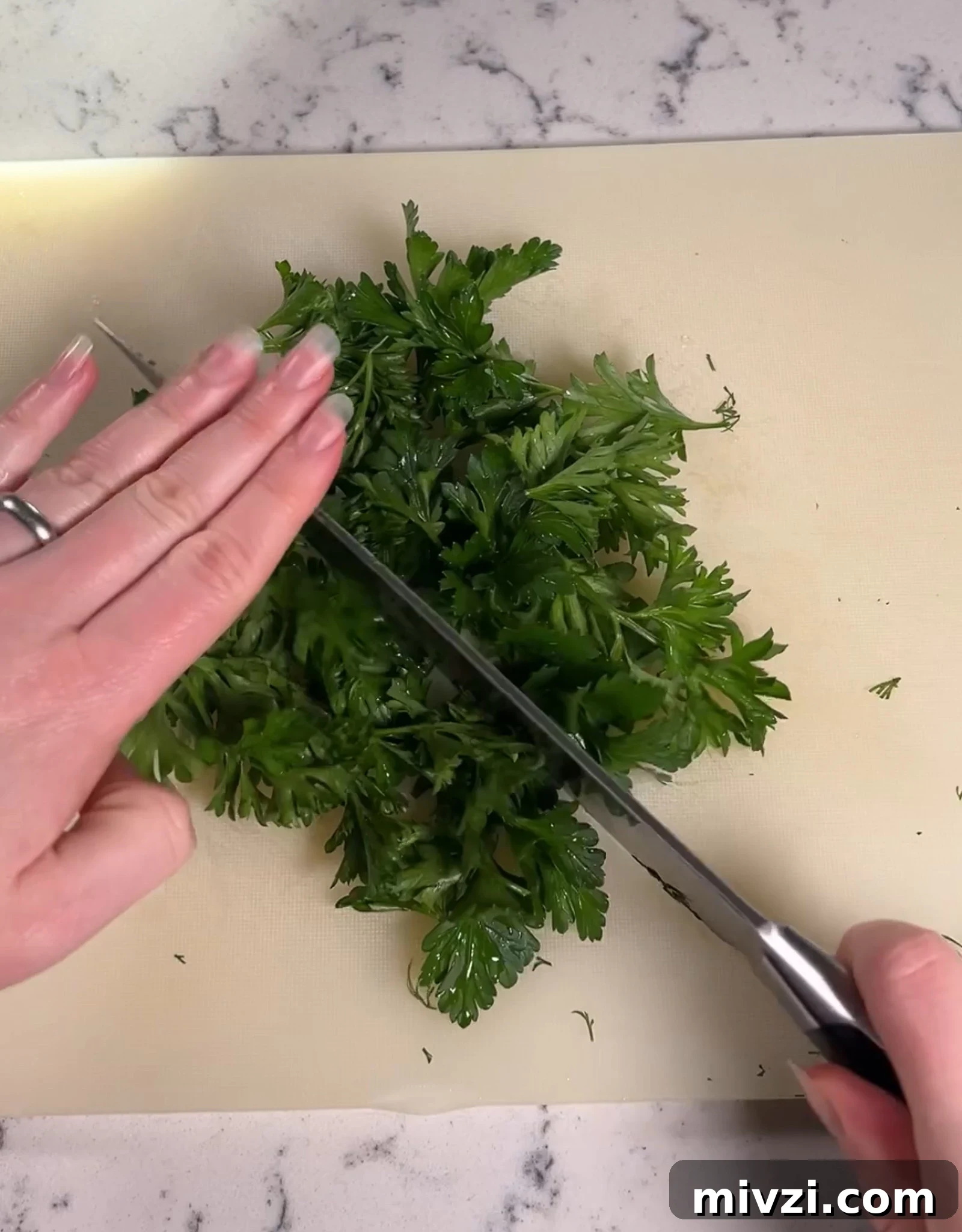 Chopping up parsley to add to the dip.