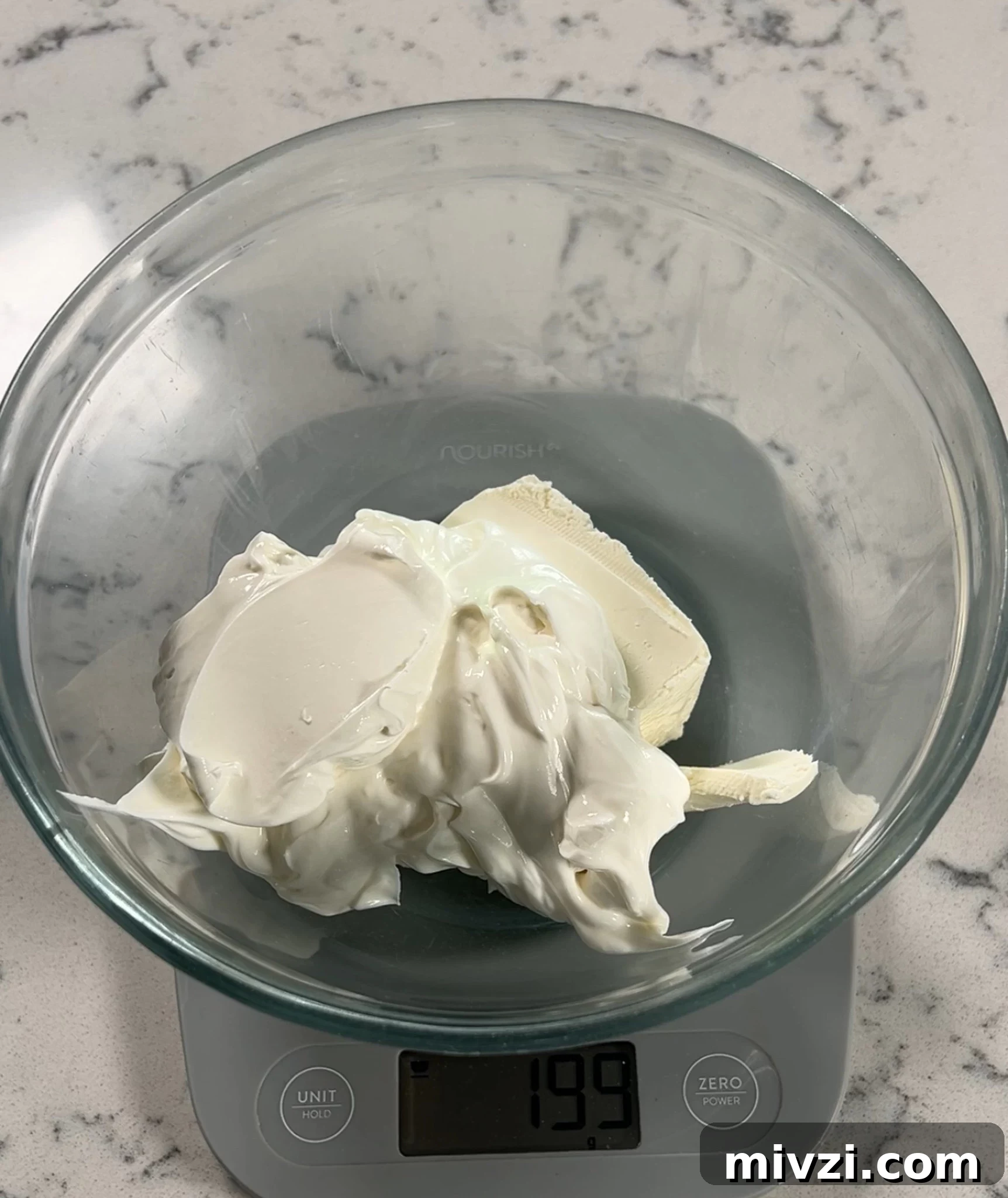 Adding cream cheese and sour cream to a bowl.