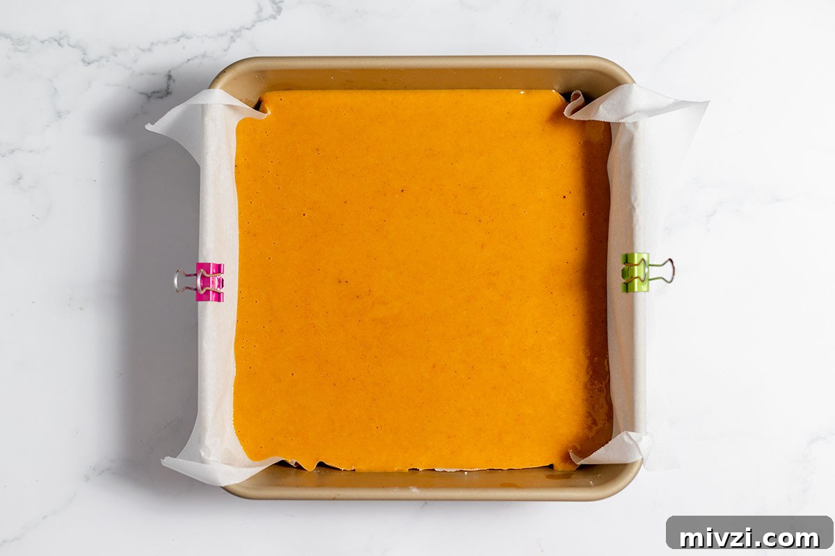 Creamy Pumpkin Pie Bars with Gingersnap Crust — Fall Dessert Recipe 9 Pumpkin Pie Bar filling poured over crust in baking pan.