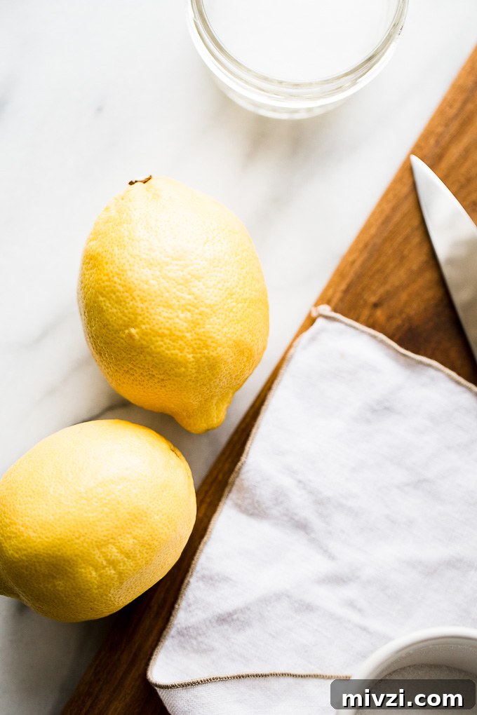 Preserve Lemons at Home: Simple Step-by-Step Guide 2 Lemons and salt on a table.