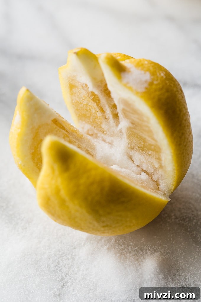 Preserve Lemons at Home: Simple Step-by-Step Guide 3 A lemon cut into quarters with salt on it.