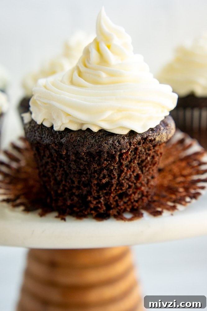 chocolate cupcake with vanilla buttercream on an open liner