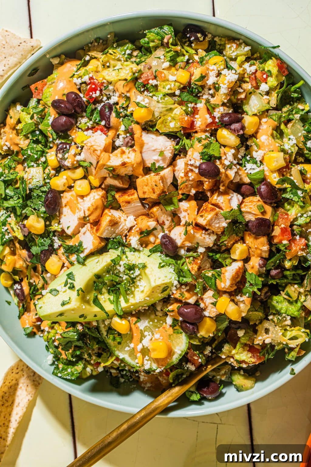 Southwest Chopped Salad Recipe with Avocado and Lime Dressing 3 southwest chopped salad with chipotle lime dressing in large blue bowl