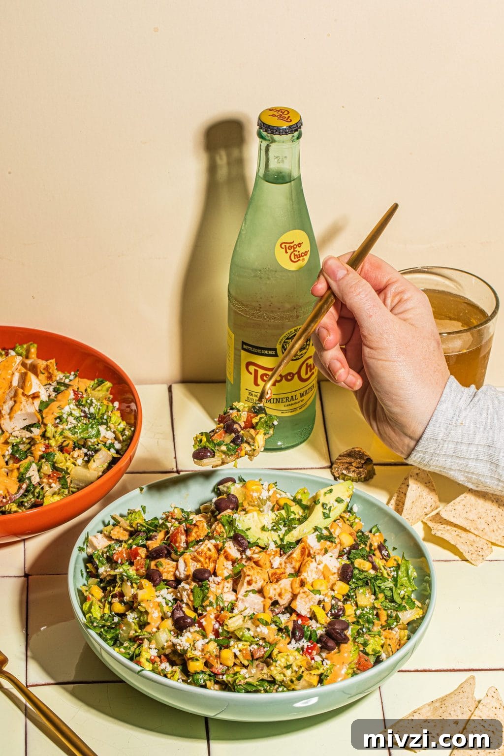 Southwest Chopped Salad Recipe with Avocado and Lime Dressing 6 gold fork digging into large bowl of southwest salad
