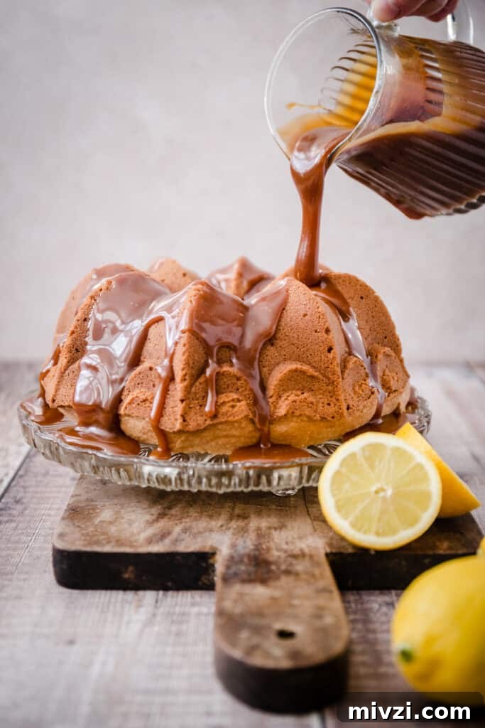 Gluten-Free Lemon Bundt Cake with Tangy Lemon Caramel 6 Caramel being poured onto lemon caramel cake