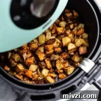 air fryer breakfast hash in an air fryer basket