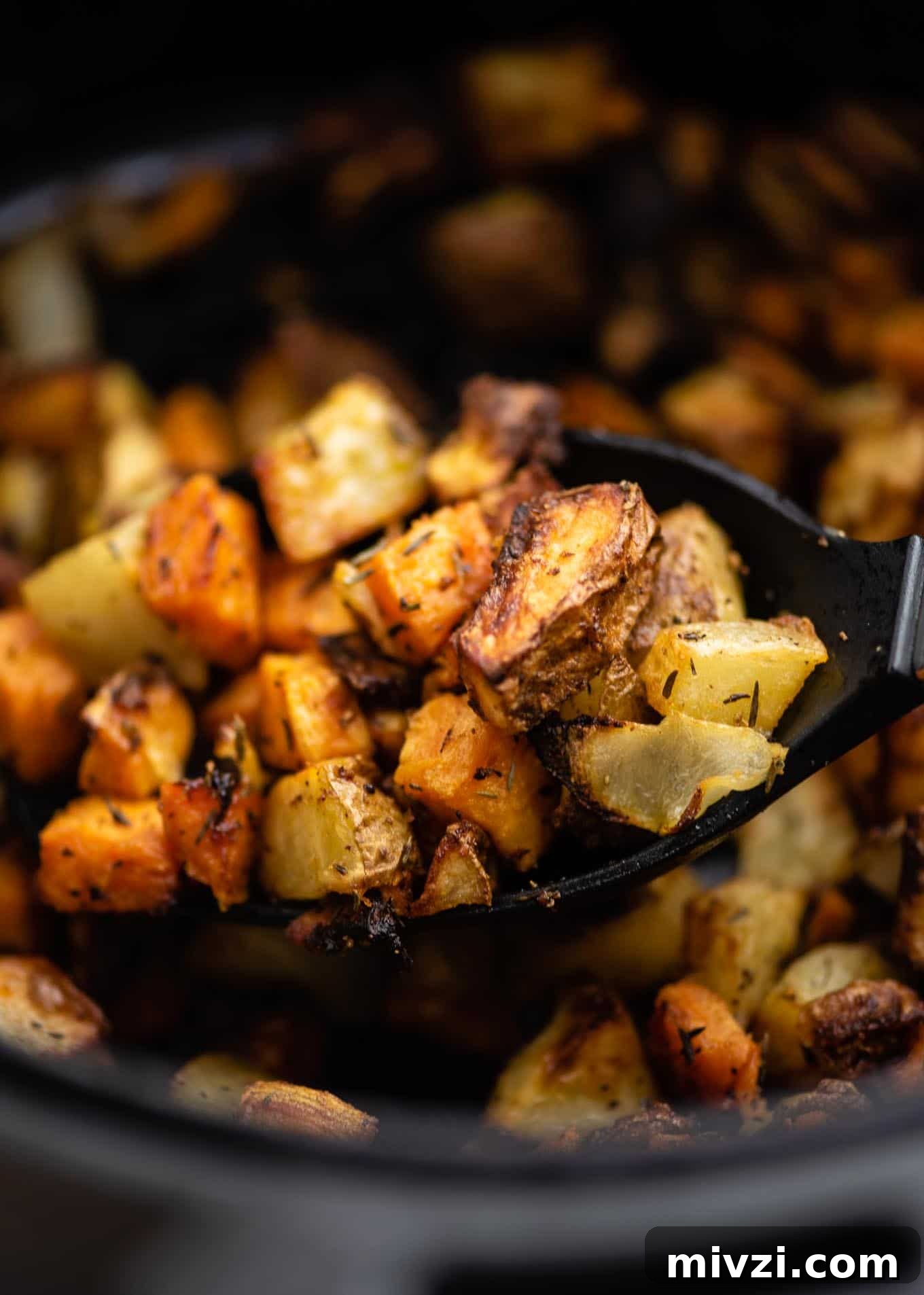 Crispy Air Fryer Breakfast Potatoes Recipe 8 spoon with a scoop of potatoes and onions
