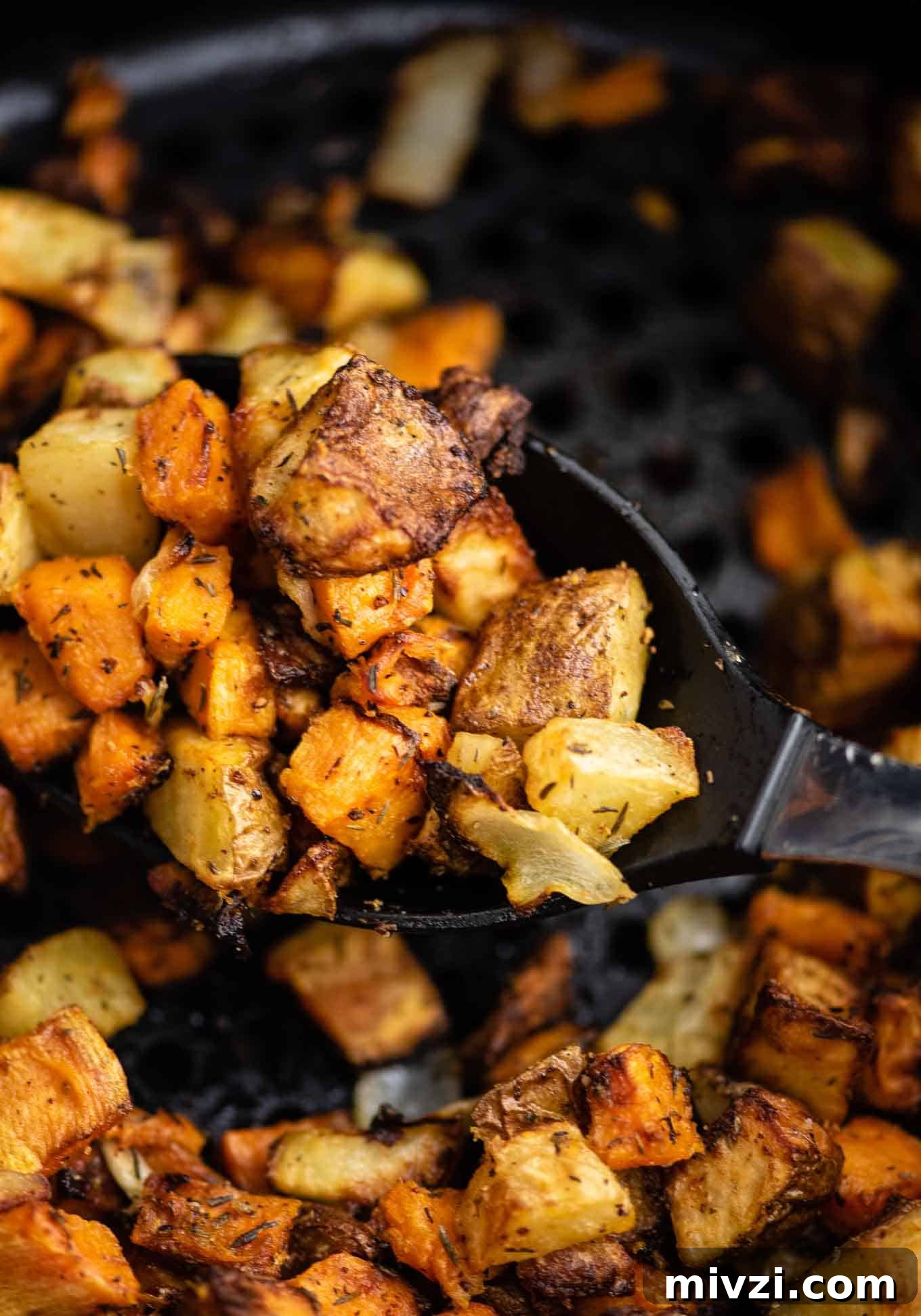 Crispy Air Fryer Breakfast Potatoes Recipe 10 air fryer sweet potatoes and russet potatoes on the serving spoon
