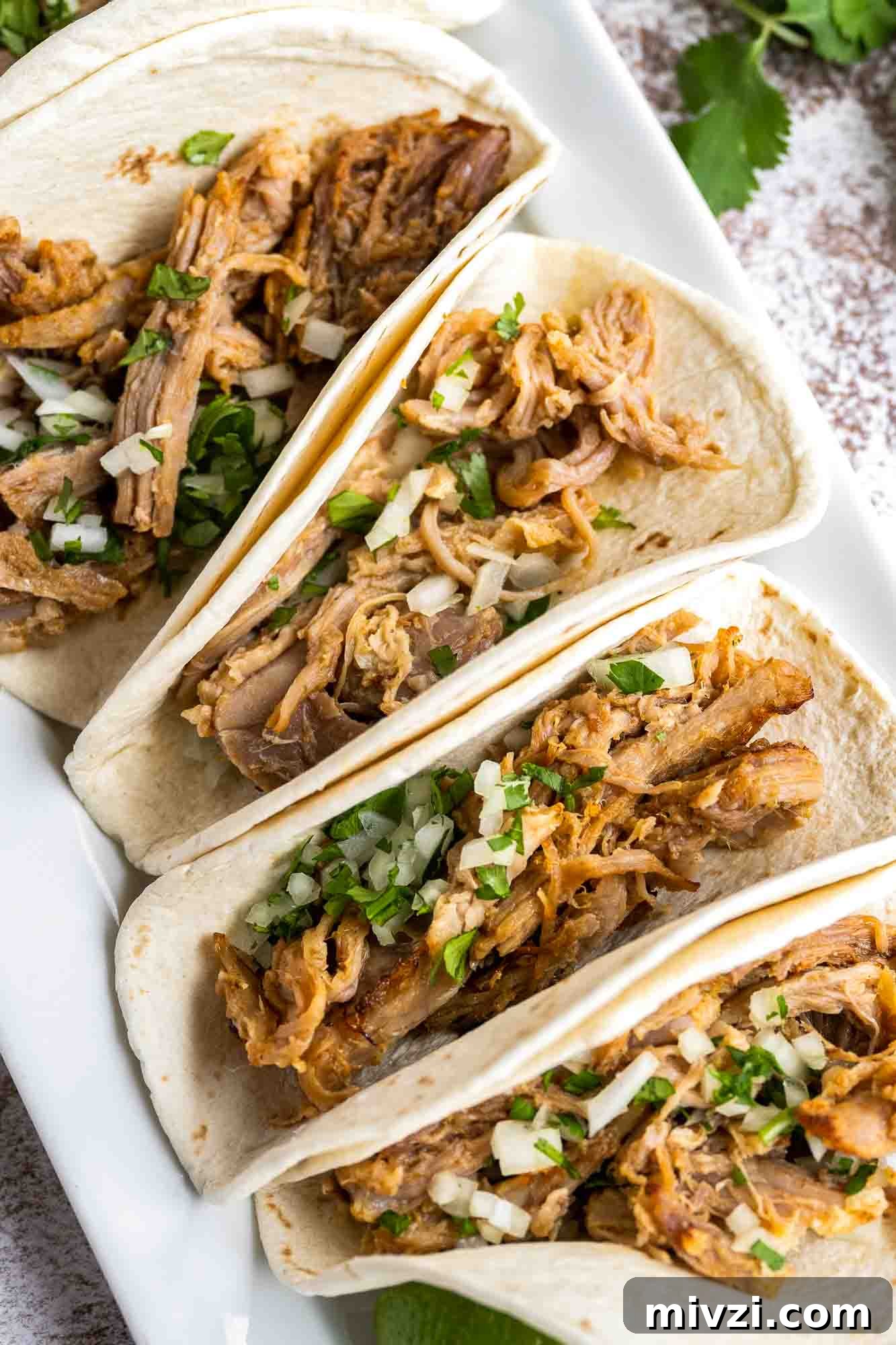 Tender Instant Pot Carnitas Recipe for Quick Mexican Pulled Pork 6 Carnitas tacos in a white platter