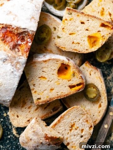 gluten free jalapeño cheddar bread with sharp cheddar and pickled jalapenos, sliced, on a sheet tray