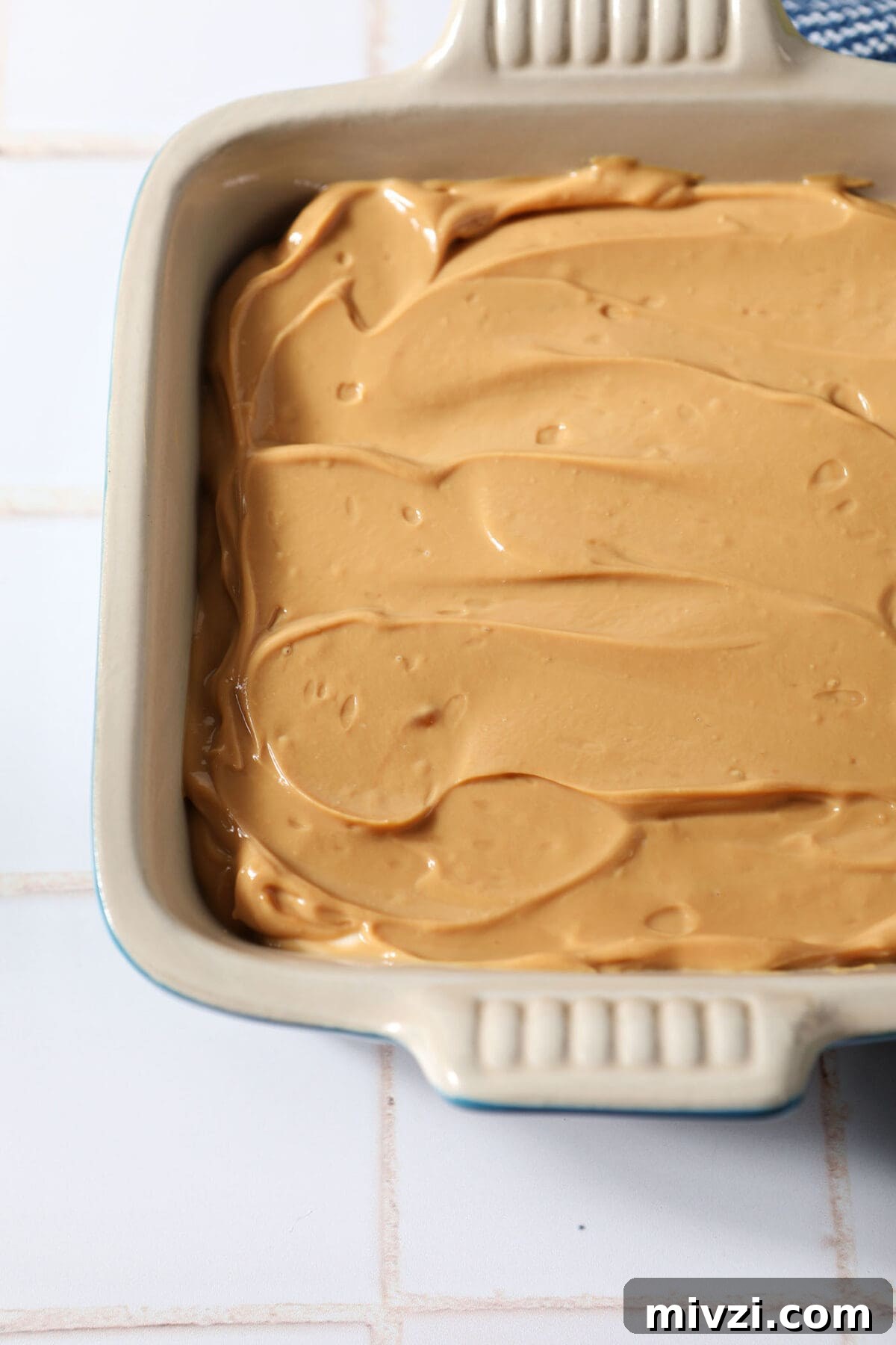 Creamy Dulce de Leche Dip Recipe for Desserts and Snacks 2 Close up of Dulce de Leche Caramel Dip in a serving dish on a white tiled surface