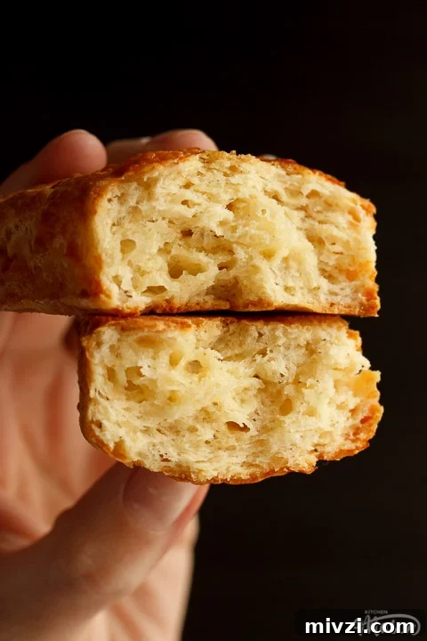 Two halves of a cheese scone showing the light flaky centre