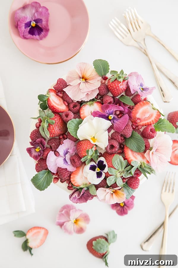 Pink Velvet Cake Recipe with Simple Decorating Tips 3 Top down shot of pink velvet cake with flowers and berries