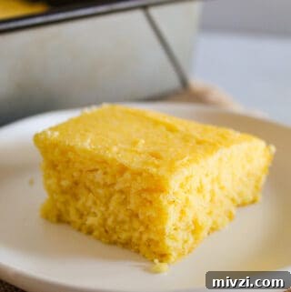 Fluffy Gluten-Free Cornbread Recipe: Simple, Light, and Moist 11 slice of gluten free cornbread on a white plate.