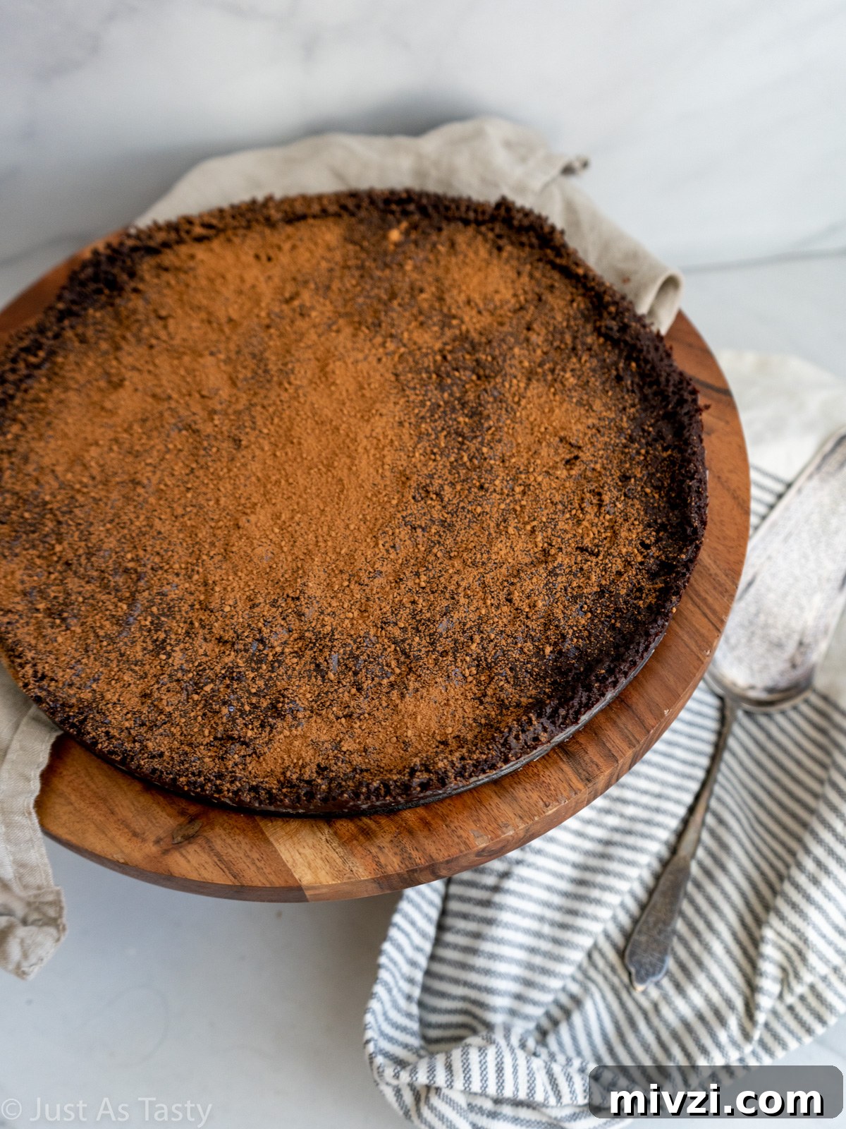 Decadent Flourless Chocolate Cake — Gluten-Free & Eggless 4 Flourless chocolate cake topped with cocoa powder.