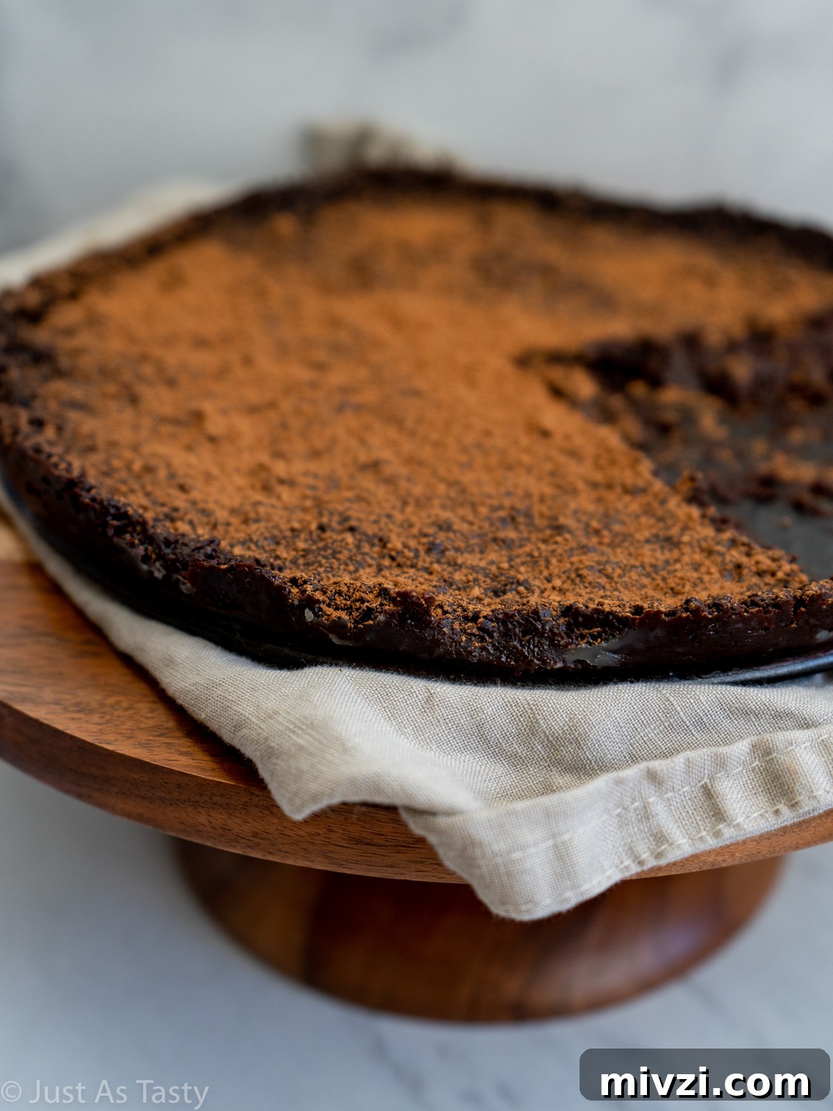 Decadent Flourless Chocolate Cake — Gluten-Free & Eggless 5 Close-up of flourless chocolate cake that has been cut into.