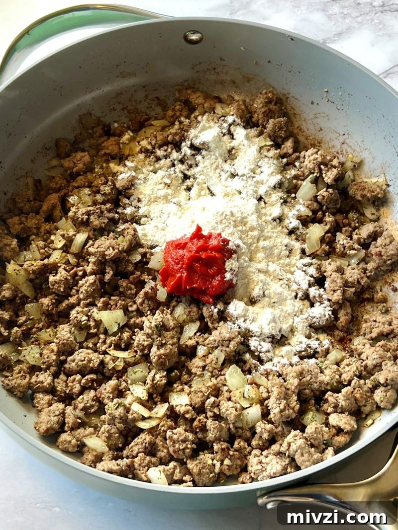 Classic Shepherd's Pie Recipe with Savory Beef and Mashed Potato Topping 5 Flour and tomato paste mixed with cooked ground beef.