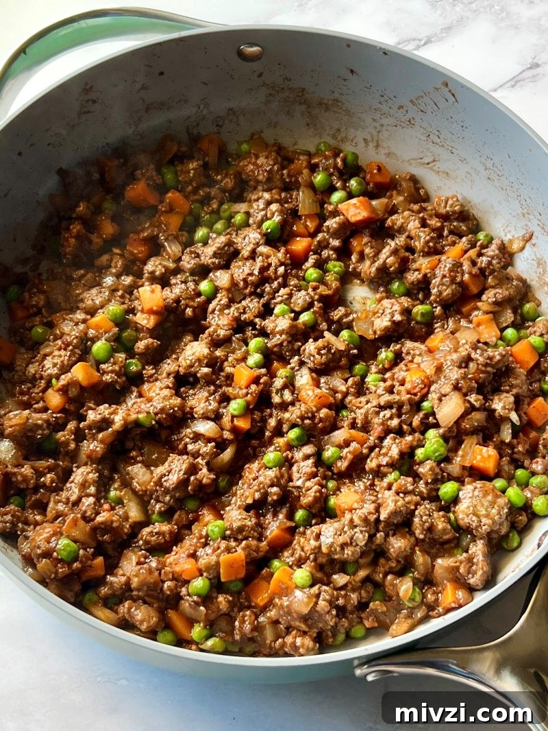 Classic Shepherd's Pie Recipe with Savory Beef and Mashed Potato Topping 6 Beef broth, wine and seasonings mixed with ground beef.