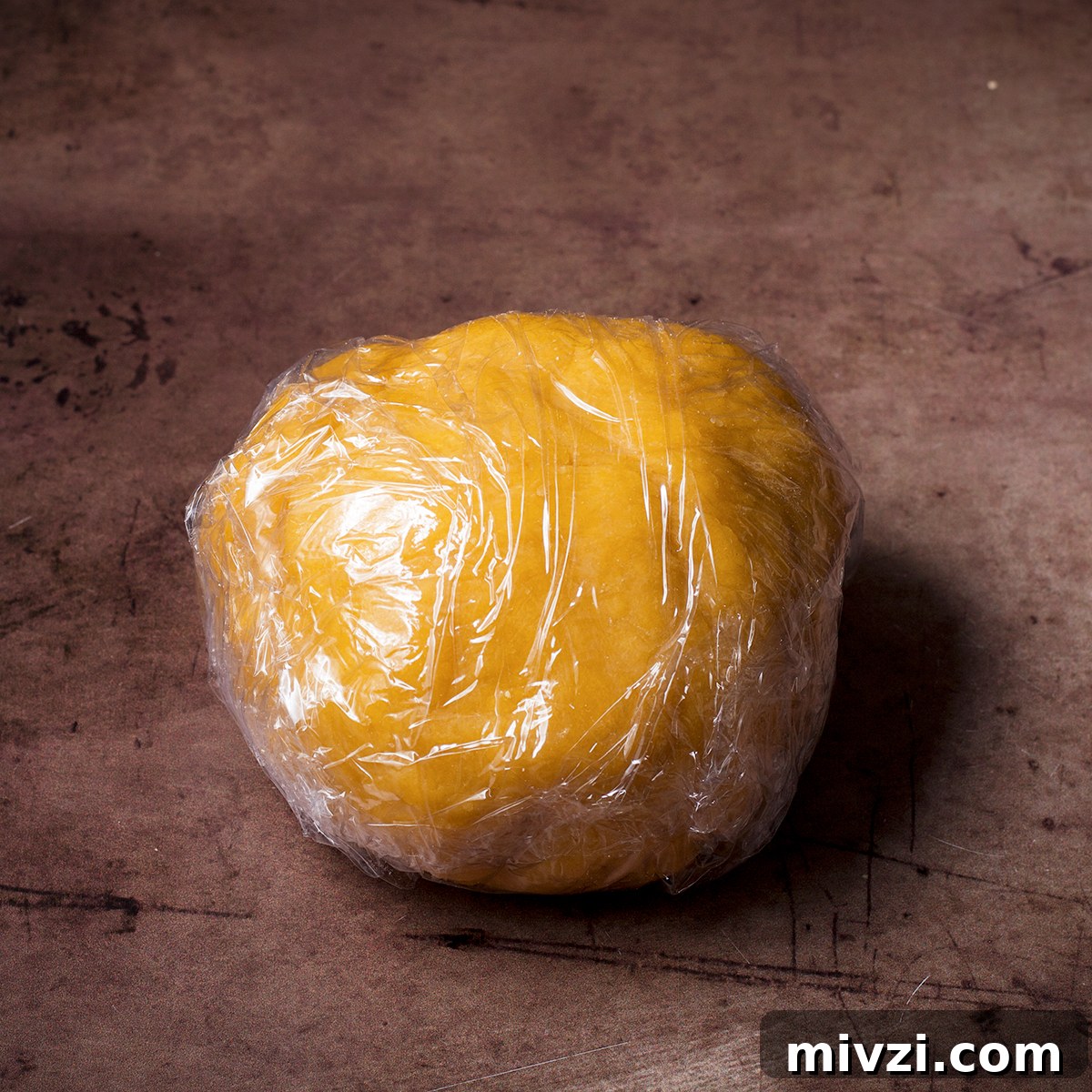 Homemade Pappardelle Recipe: Fresh Pasta from Scratch 11 A ball of homemade pasta dough that's been wrapped in plastic wrap.