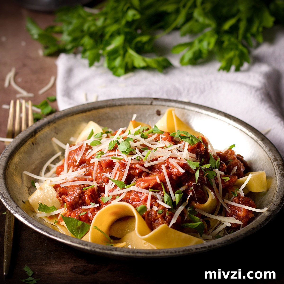 Homemade Pappardelle Recipe: Fresh Pasta from Scratch 23 A plate filled with homemade pappardelle noodles covered in bolognese sauce.