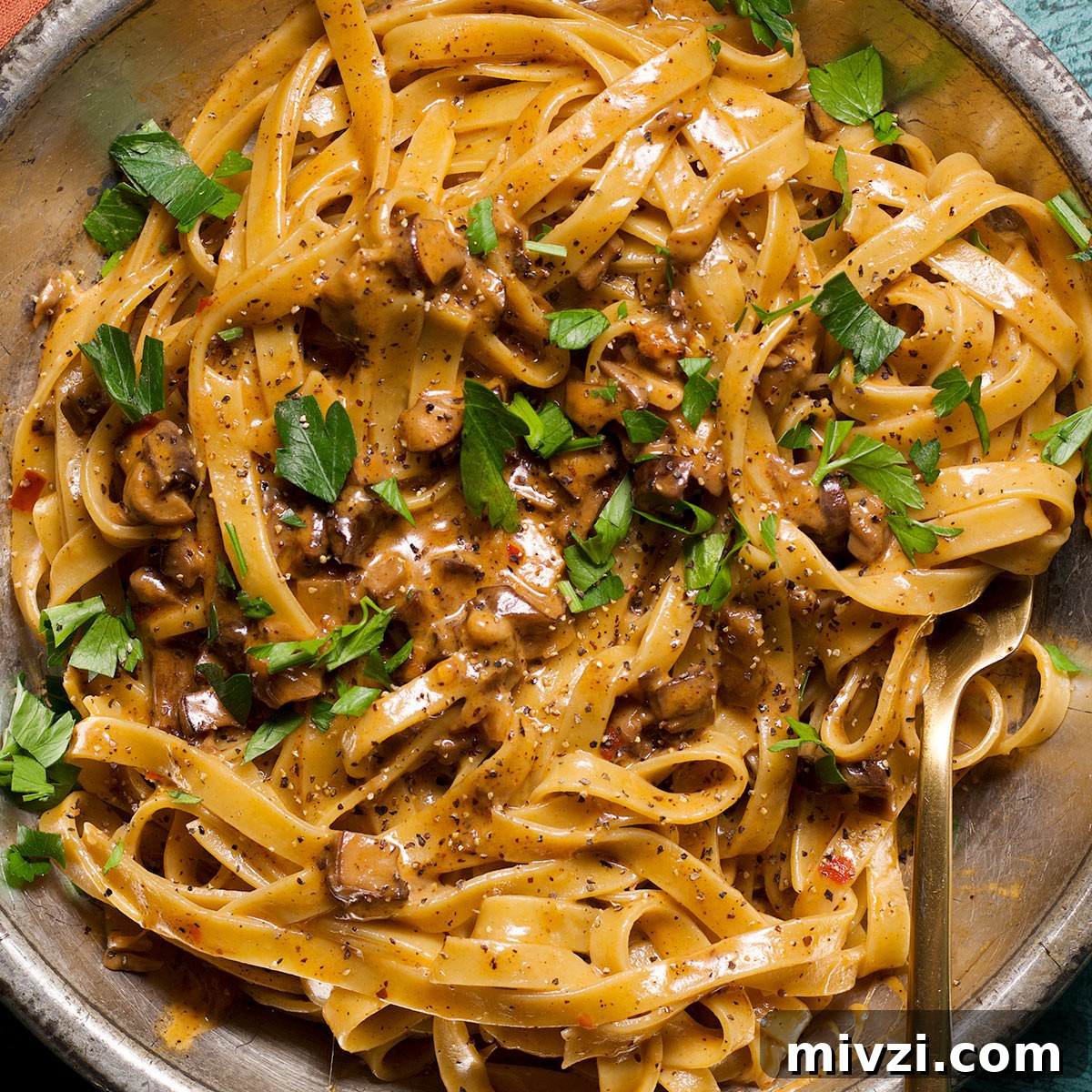 Homemade Pappardelle Recipe: Fresh Pasta from Scratch 24 A plate full of pasta coated in creamy mushroom ragu sauce.
