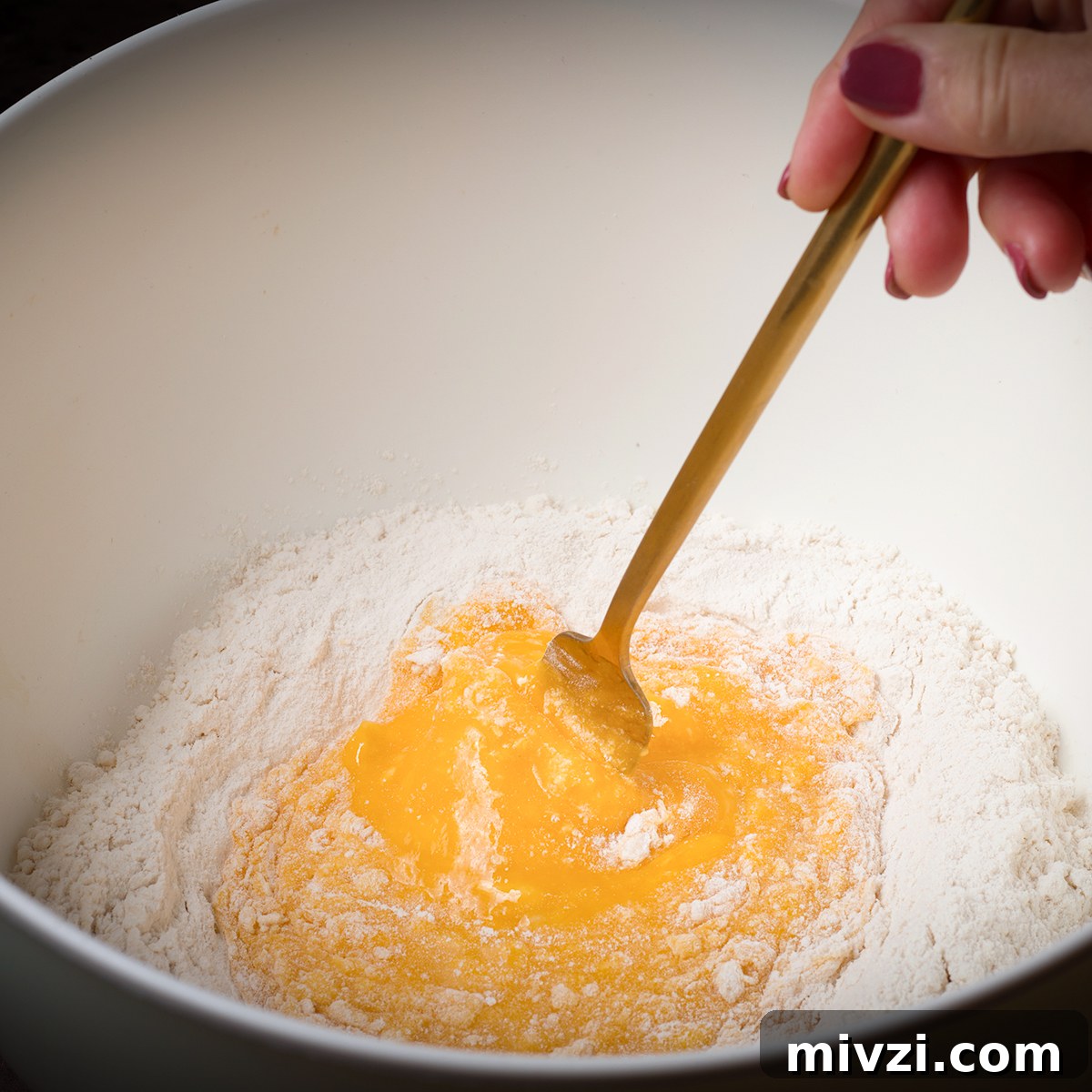 Homemade Pappardelle Recipe: Fresh Pasta from Scratch 7 Using a fork to slowly blend eggs into flour.