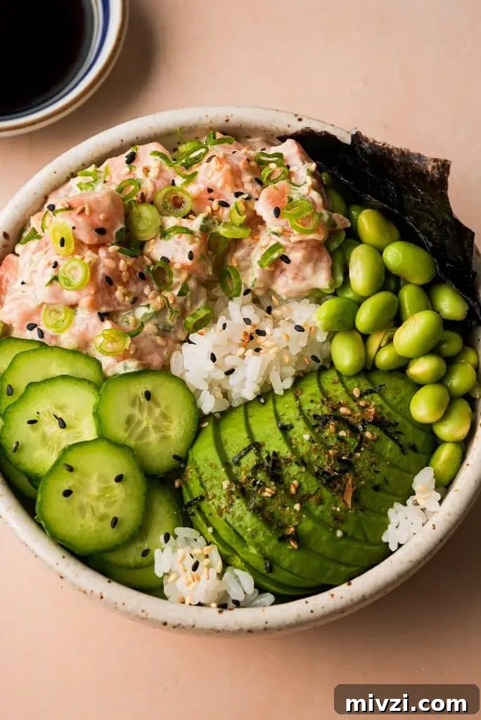 salmon poke bowl with a side of ponzu sauce