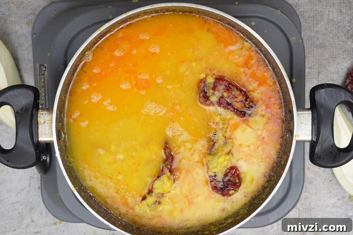 Tangy Raw Mango Dal Recipe for Flavorful Indian Lentils 10 Water and salt added to the pan.