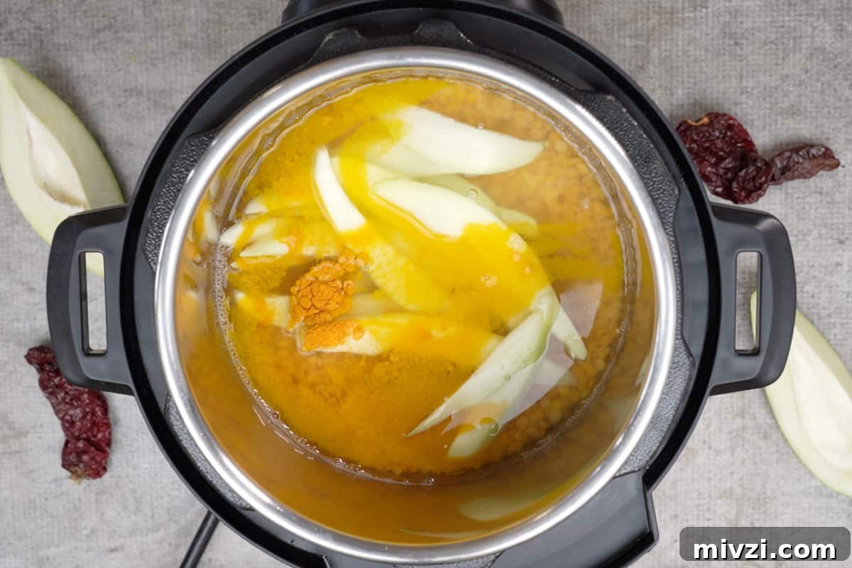 Tangy Raw Mango Dal Recipe for Flavorful Indian Lentils 3 Dal, green mangoes, turmeric and water added to instant pot.