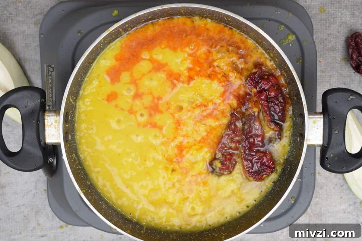 Tangy Raw Mango Dal Recipe for Flavorful Indian Lentils 9 Dal poured in the pan.