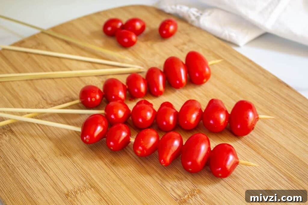 Oven-Roasted Cherry Tomatoes with Garlic and Herbs 5 Cherry tomatoes skewered on wooden sticks.
