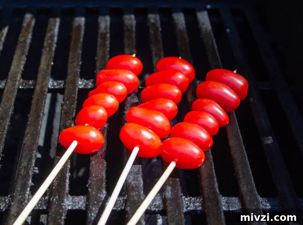 Oven-Roasted Cherry Tomatoes with Garlic and Herbs 6 Tomato skewers on a barbecue grill.