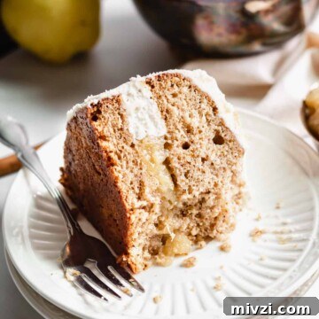 Slice of Pear Spice Cake on a plate with a bite removed