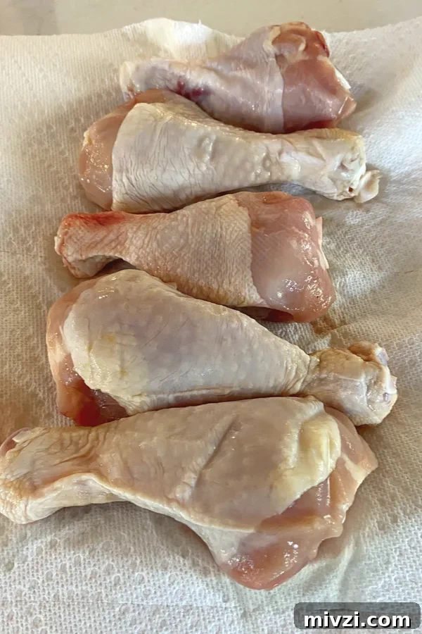 Crispy Baked Chicken Legs (No Breading) 3 chicken legs on paper towel