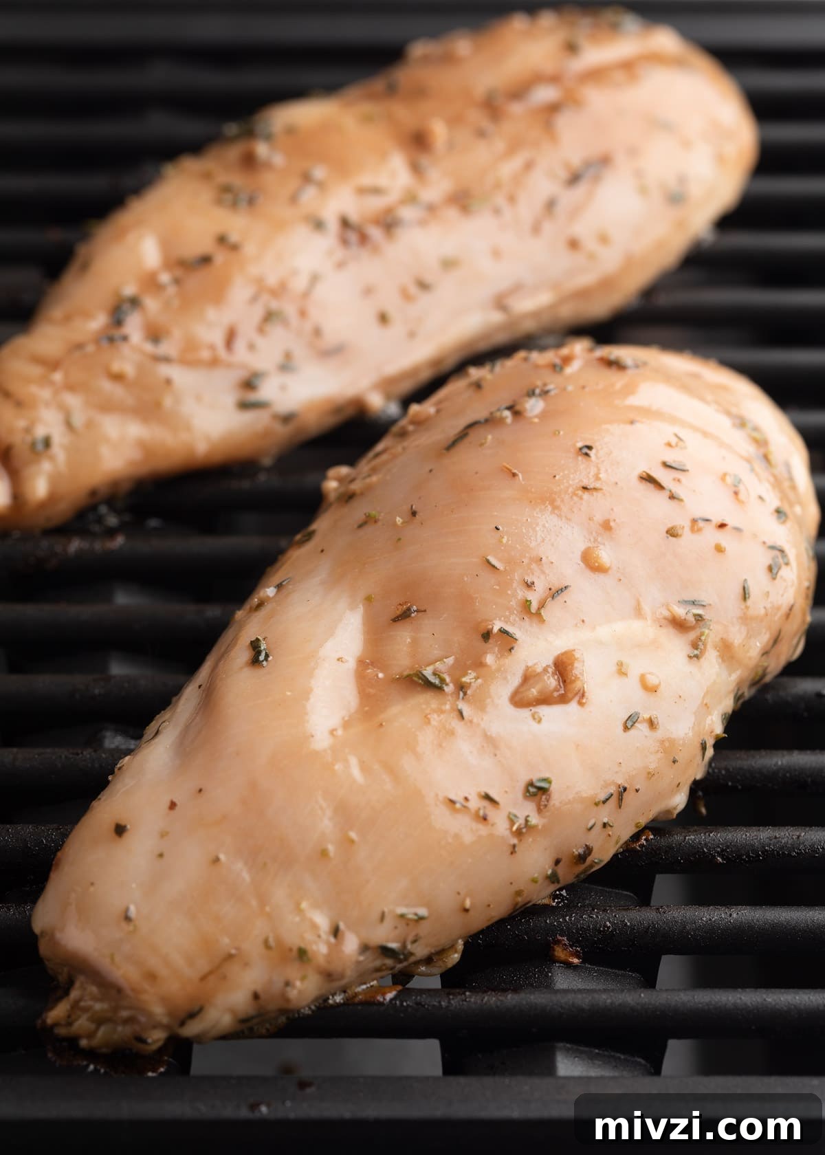 Balsamic-Marinated Chicken Breasts for Juicy Weeknight Meals 6 2 raw balsamic marinated chicken breasts on grill grates