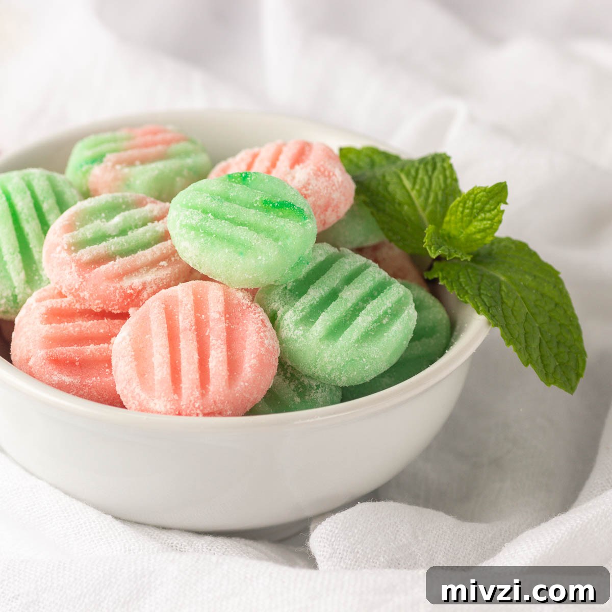 Keto Buttercream Mints: Low-Carb Peppermint Candy Recipe 2 A bowl of green and pink soft mints.