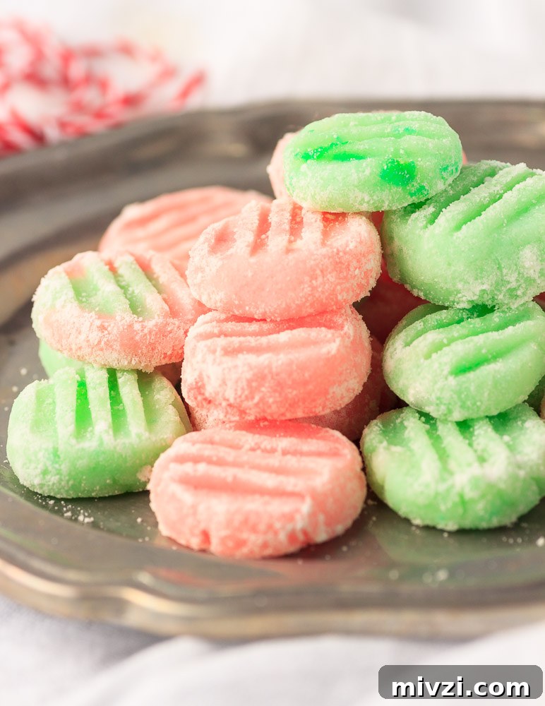 Keto Buttercream Mints: Low-Carb Peppermint Candy Recipe 5 A metal plate with butter cream mints stacked on it.