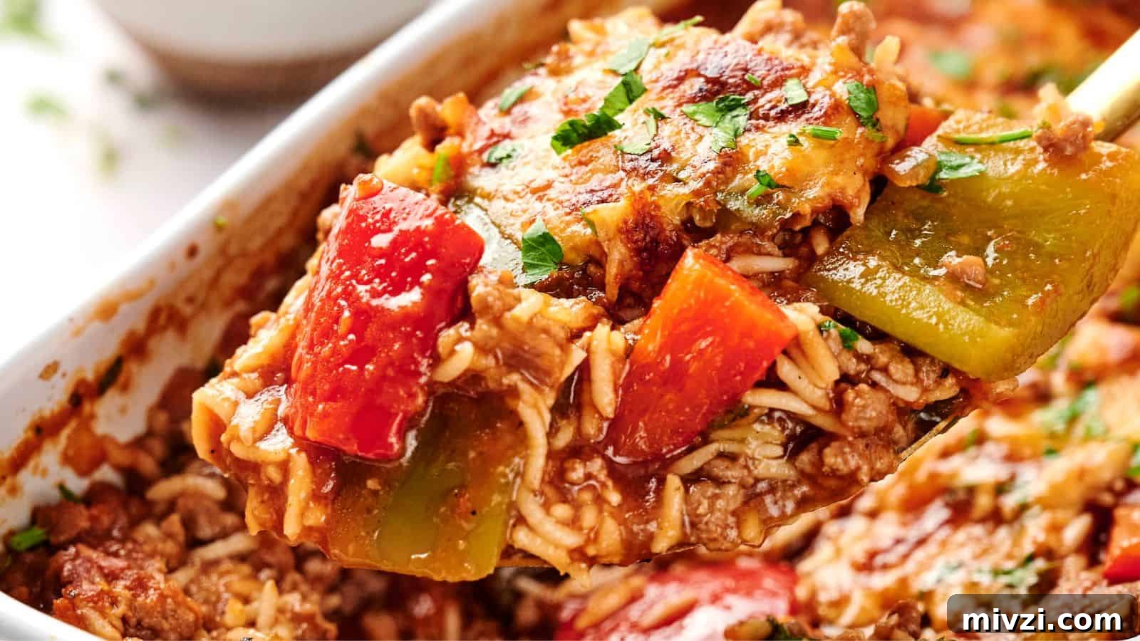 35 Comforting Casserole Recipes to Rely on Tonight 12 A spoonful of stuffed pepper casserole with ground meat, red and green bell peppers, cheese, and rice, garnished with herbs.