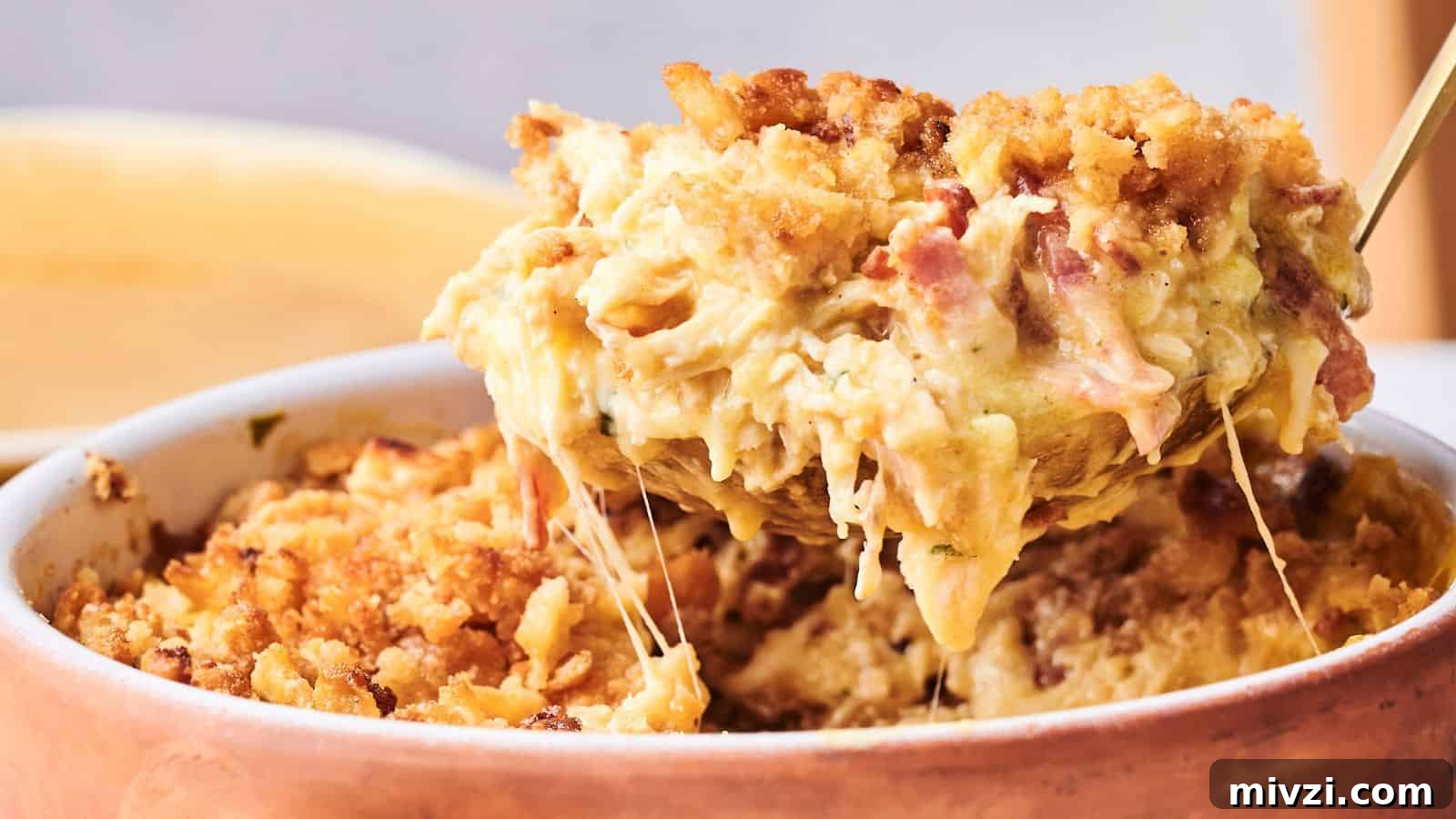 35 Comforting Casserole Recipes to Rely on Tonight 17 A spoon lifts a serving of baked macaroni and cheese with a golden breadcrumb topping and melted cheese from a casserole dish.