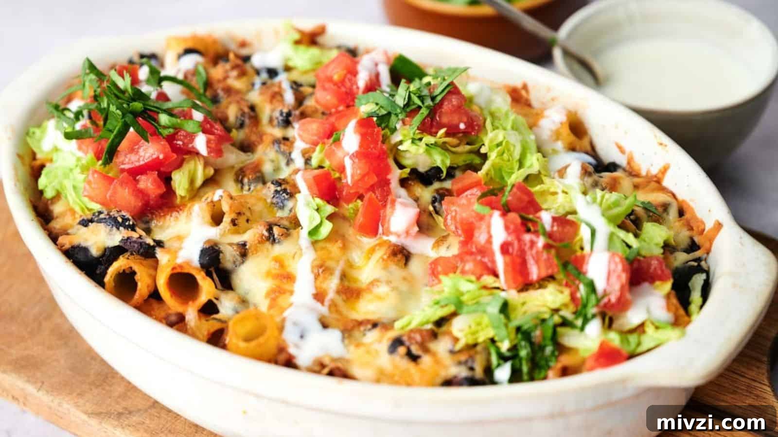 35 Comforting Casserole Recipes to Rely on Tonight 24 A freshly baked taco casserole garnished with lettuce, tomatoes, and green onions.