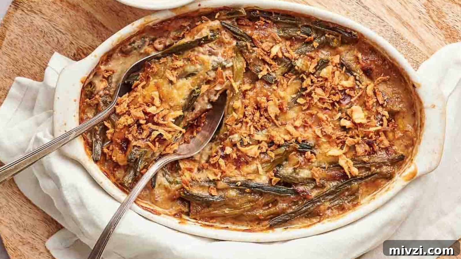 35 Comforting Casserole Recipes to Rely on Tonight 27 A casserole dish filled with green bean casserole with a spoon in it.