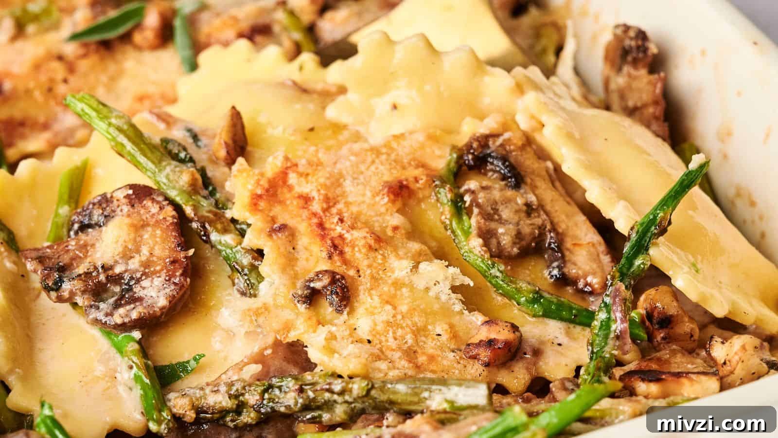 35 Comforting Casserole Recipes to Rely on Tonight 32 Close-up of a baked dish with ravioli, mushrooms, asparagus, and melted cheese on top.