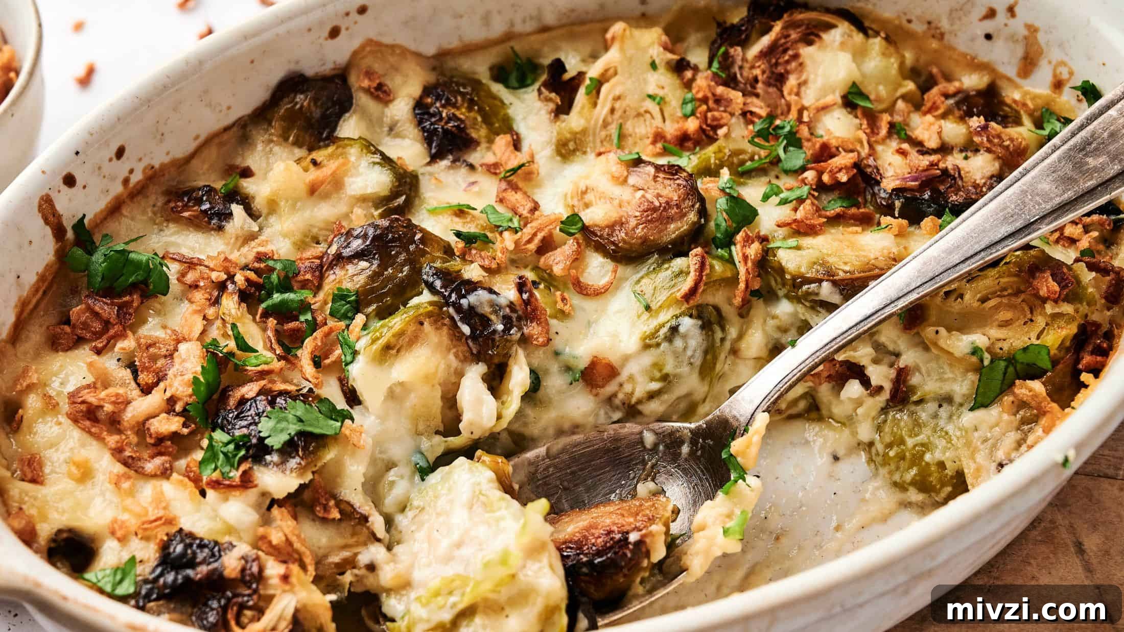 35 Comforting Casserole Recipes to Rely on Tonight 35 Casserole dish with Brussels sprouts, crispy onions, cheese, and herbs, mixed with a spoon.
